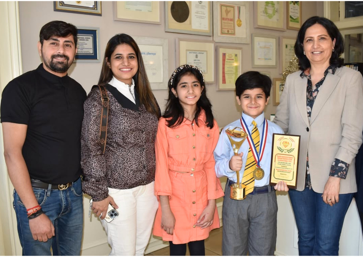 A young achiever with trophy and award, joined by family and mentors